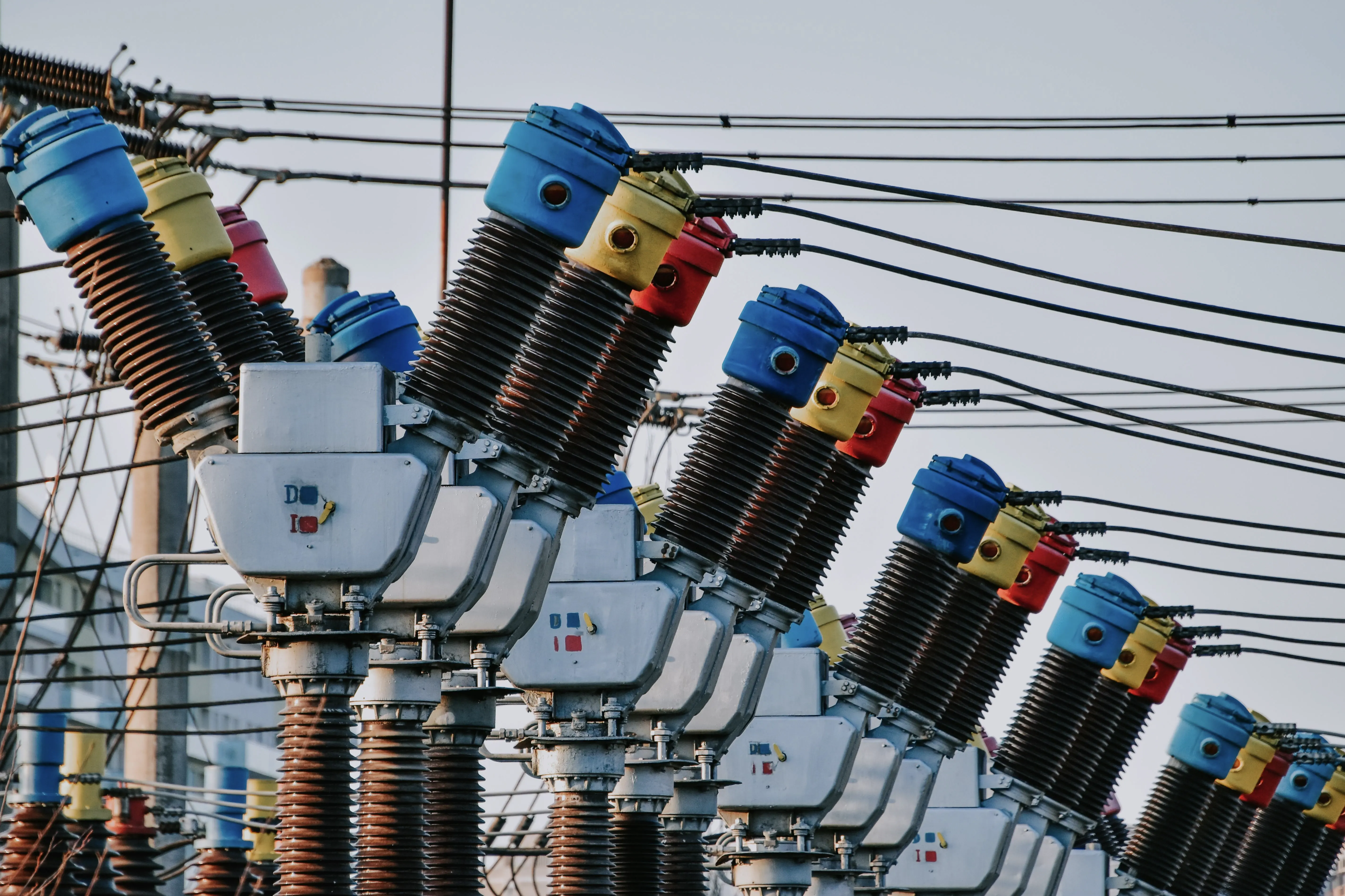 Row of high-voltage substation switchgear and insulators