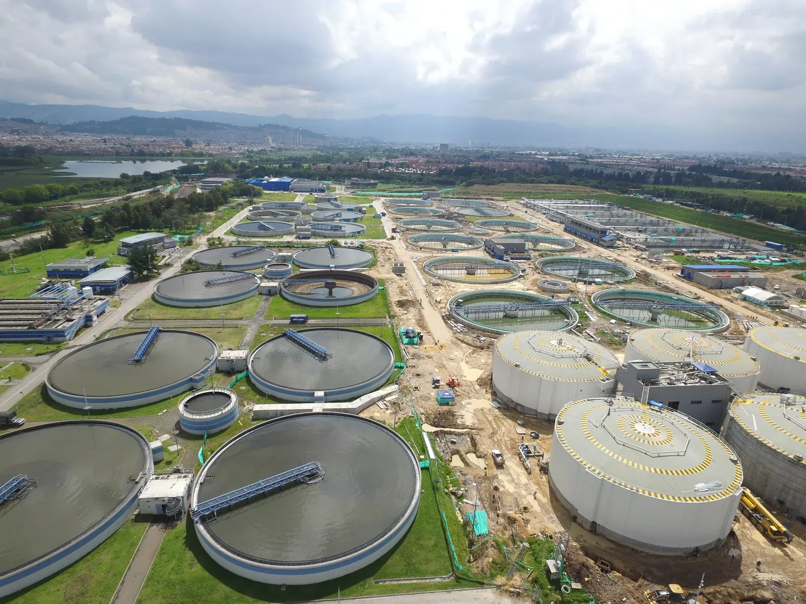 Municipal wastewater treatment infrastructure with tanks, process basins, and civic treatment scale
